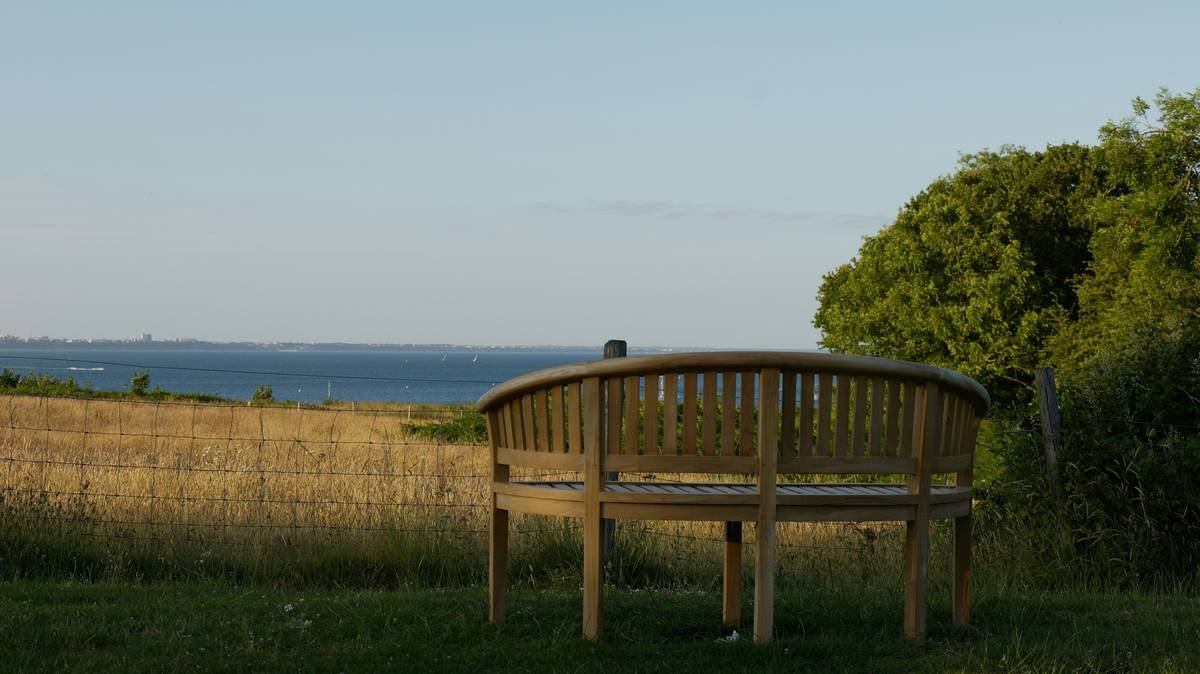 A woman smiling peacefully outdoors after adopting mindfulness practices