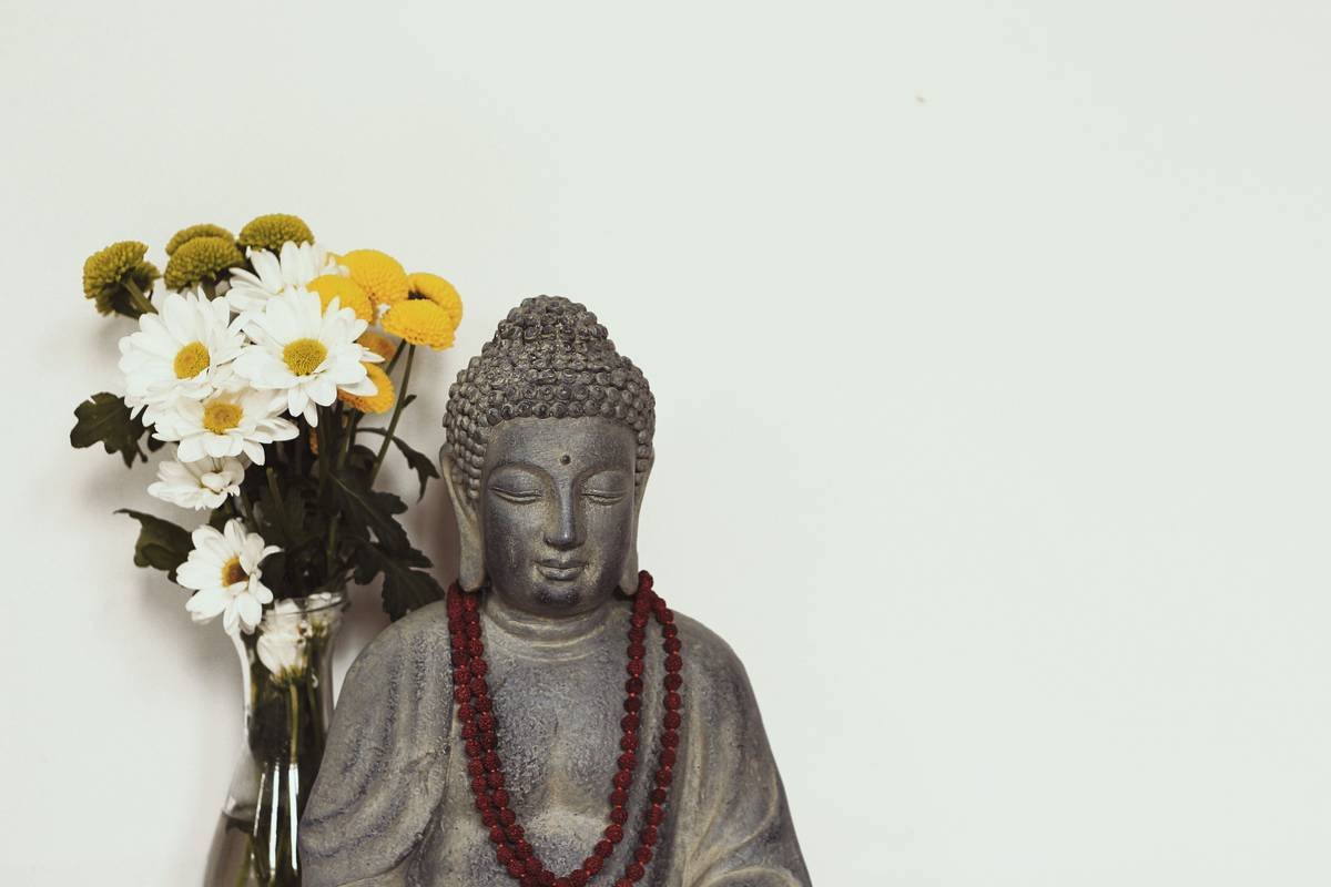 Smiling young woman sitting cross-legged after completing a meditation session