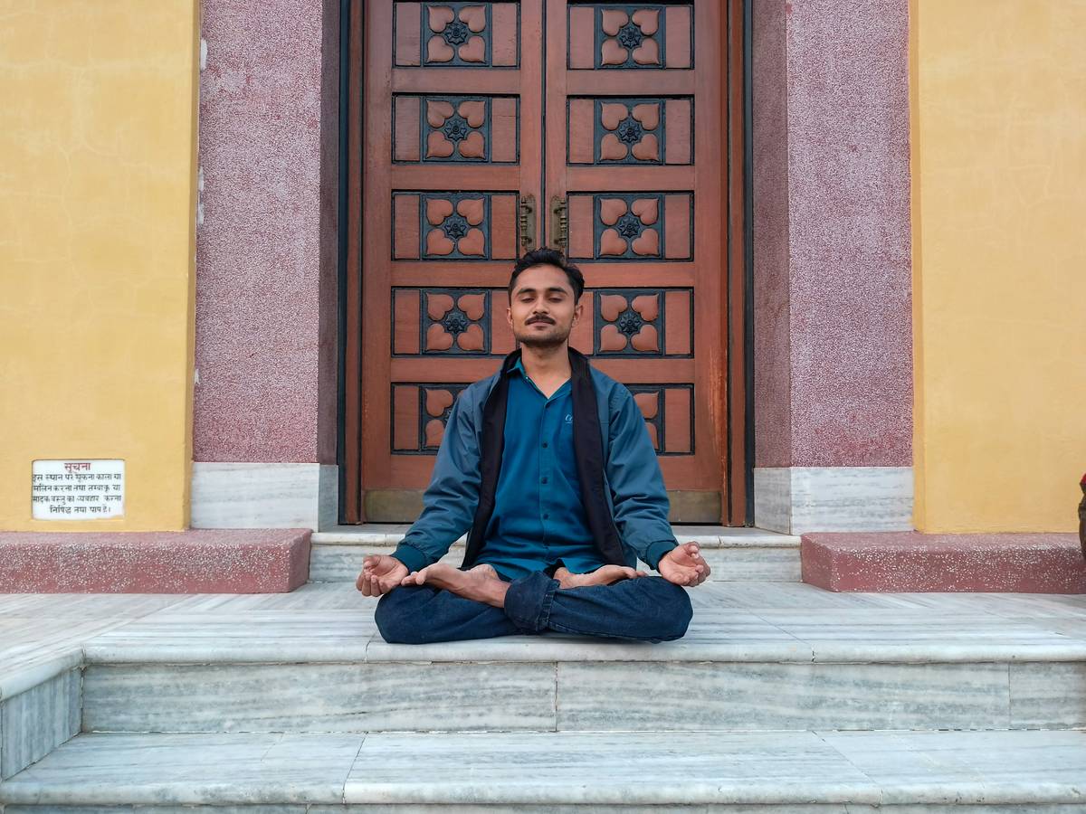 A man sitting on a step in front of a door