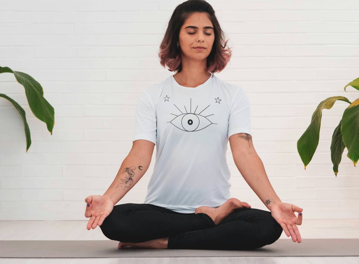 woman meditating while doing yoga